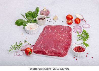 Dry aged Bavette steak with traditional spices and herbs. Fresh raw meat cut, light stone concrete background, flat lay, copy space
