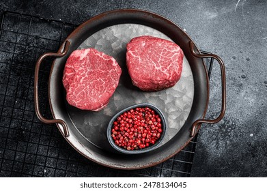 Dry aged Raw steaks fillet Mignon, Beef tenderloin. Black background. Top view. - Powered by Shutterstock