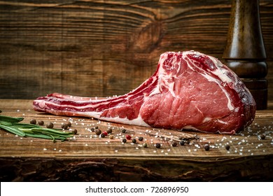 Dry Aged Raw Tomahawk Beef Steak With Ingredients For Grilling