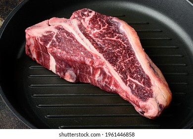 Dry Aged T Bone Marbled Beef Steak Set, In Frying Cast Iron Pan, On Old Dark Rustic Background