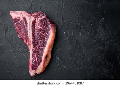 Dry Aged T Bone Marbled Beef Steak Set, On Black Stone Background, Top View Flat Lay, With Copy Space For Text