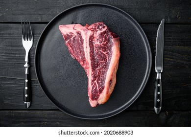 Dry Aged T Bone Marbled Beef Steak Set, On Plate, On Black Wooden Table Background, Top View Flat Lay