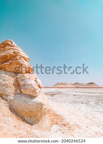 Dry arid desert landscape in Ustyurt plateau, Mangystau.  Senek village covered by sand dunes. Bozzhira mountain located at Tethys ocean drying. National park Altyn-Emel. Extreme heat global warming
