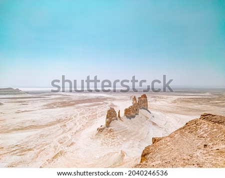 Dry arid desert landscape in Ustyurt plateau, Mangystau.  Senek village covered by sand dunes. Bozzhira mountain located at Tethys ocean drying. National park Altyn-Emel. Extreme heat global warming