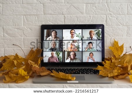 dry autumn leaves and videocall by laptop computer