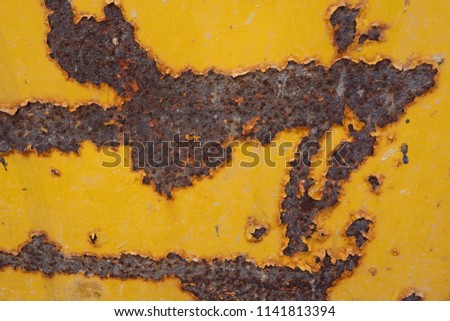 Dry big patch of rusted surface texture on peel yellow painted metal. Old material deteriorate condition from normal work used and weathered environment. For background use rusty metal sheet concept. 