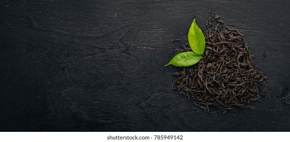 Dry Black Tea. On A Wooden Background. Top View. Copy Space.