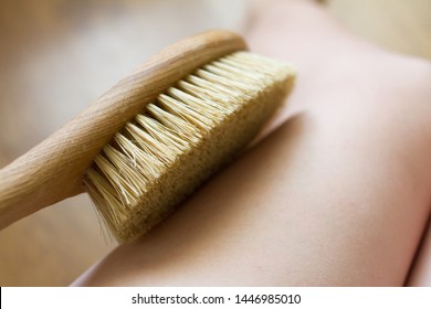 Dry Brush Massage. Girl Massages Her Leg With A Brush Against Cellulite