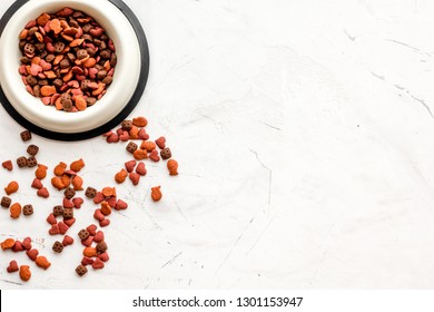 Dry Cat Food In Bowl On White Stone Backgorund Top View Copy Space