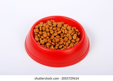 Dry cat food in red plastic bowl isolated on white. Cat and dog dry food in bowl 
