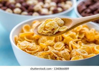 Dry, Cereals Breakfast. Spoon And Bowl With Frosted Yellow Corn Flakes 