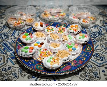 Dry chocolate cake covered with white cream with various toppings, nuts, chocolate sprinkles and candy - Powered by Shutterstock