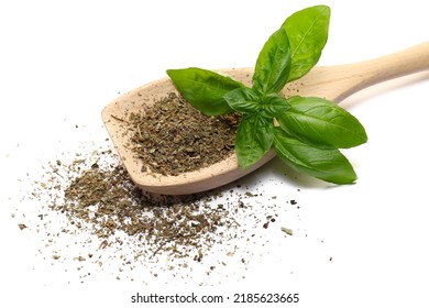 Dry Chopped Basil In Wooden Spoon And Fresh Basil Green Leaves Isolated On White  