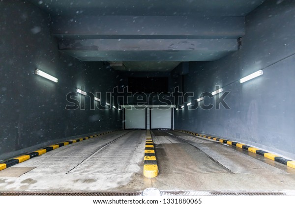 Dry And Clean\
Entrance To The Underground Garage Or Parking Of The Office\
Building In Winter During\
Snowfall