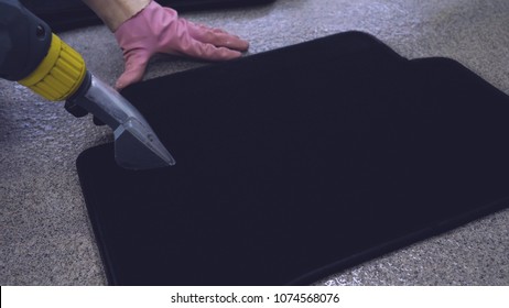 Dry Cleaning Of Black Mats For Cars, Vacuum Cleaner Removes Dirt, Pink Rubber Gloves, Car Washing.