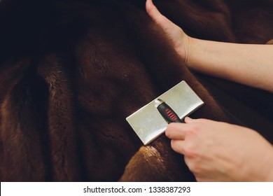 Dry Cleaning Business Concept. Woman Working With Fur Coat And Brush.