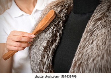 Dry Cleaning Business Concept. Woman Working With Fur Coat And Brush