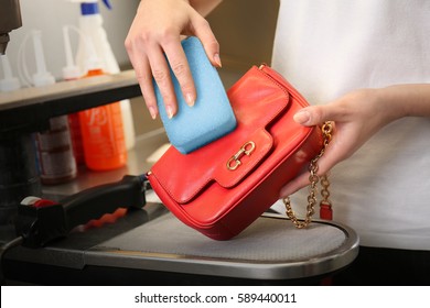 Dry Cleaning Business Concept. Woman Washing Bag With Sponge