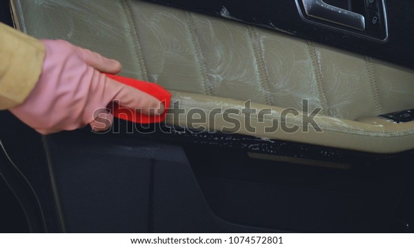 Dry cleaning of the car panel, a rag, pink\
rubber gloves, car washing.