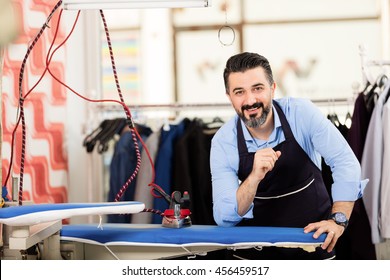 Dry Cleaning Owner Posing In His Shop.