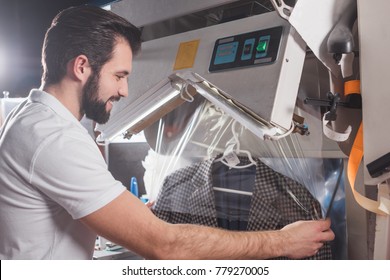 Dry Cleaning Worker Packing Jacket In Plastic Bag