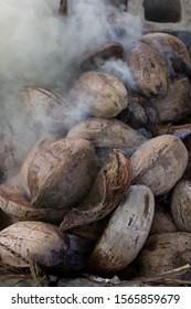 Dry Coconut Husks Burning And Smoking Within Concrete Blocks. A Traditional Rarotongan Method Of Cooking Food Called An Umu. An Ancient Polynesian Culture Of The Cook Islands In The South Pacific.