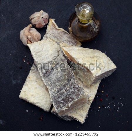 dry cod fish on black ceramic background