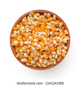Dry corn in bowl isolated on white background, top view