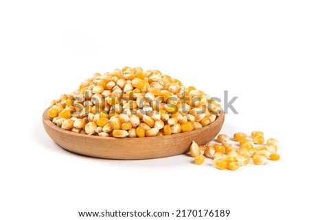 dry corn in plate isolated on white background.Unpopped popcorn