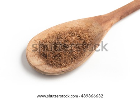 Dry Corn Silk Herb into a spoon isolated in white background. Stigmata Maydis
