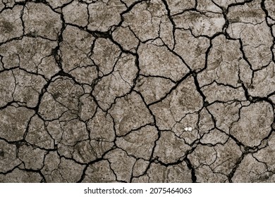 Dry cracked earth, parched land, Earth dirt texture background of brown mud, arid soil, Dry cracked earth texture, cracked earth, Dry mud, broken texture, desert, Global Warming, Climate Change.