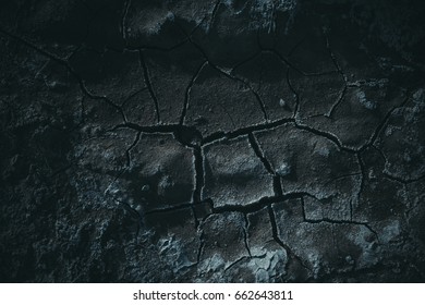 Dry Cracked Ground. Dark Background