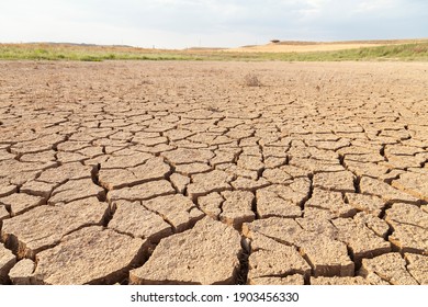 Dry and cracked land, dry due to lack of rain, in the Loteta reservoir, near the town of Gallur, Spain. Effects of climate change such as desertification and droughts.