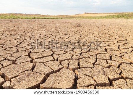 Dry and cracked land, dry due to lack of rain, in the Loteta reservoir, near the town of Gallur, Spain. Effects of climate change such as desertification and droughts.