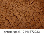 Dry and cracked red brown soil ground during drought, viewed from above. top view. earthquake cracking holes, cracked wall, ground cracks top view, ruined land surface crushed texture. destruction