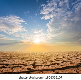 dry cracked waterless plain at the sunset, dramatic ecological disaster background