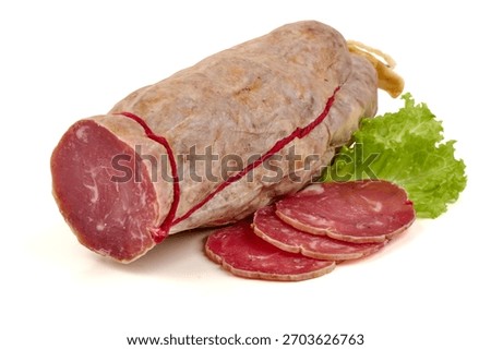 Dry cured saucisson sec, a rustic French sausage, with mold ripened casing and sliced pieces, isolated on white background