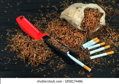 Dry Cut Tobacco Leaf, Cigarettes And Cigarette Machine On Wooden Table. Handmade Cigarettes