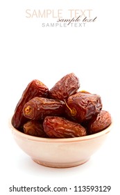Dry dates in bowl on white background