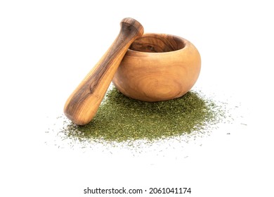 Dry dill leaves near mortar and pestle on white background