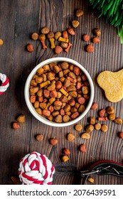 Dry Dog Food In Bowl On Wooden Background Top View