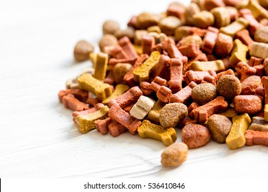 Dry Dog Food In Bulk On Wooden Background Close Up