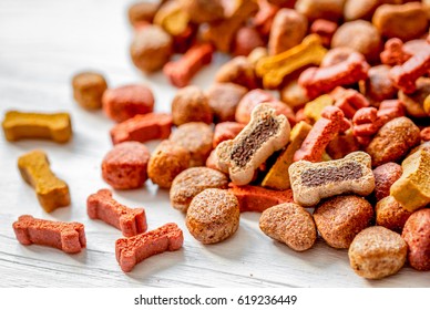 Dry Dog Food In Bulk On Wooden Background Close Up