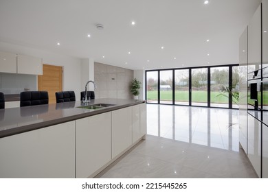 Dry Drayton, Cambridgeshire - Jan 10 2017: Contemporary Modern Kitchen Interior With Bifold Doors Leading To Garden Patio