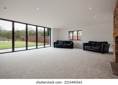 Dry Drayton, Cambridgeshire - Jan 10 2017: Contemporary New House Sitting Room Lounge With Bifold Doors To Patio And Garden