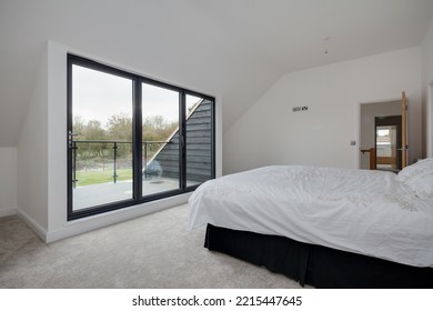 Dry Drayton, Cambridgeshire - Jan 10 2017: Contemporary New House Bedroom With Bifold Doors To Balcony