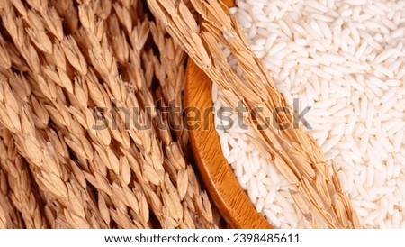 Dry ears of rice and the wooden rice bowl close up