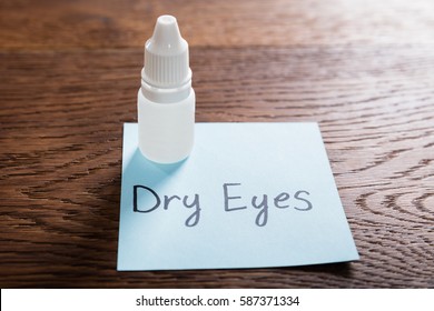 Dry Eyes Concept With Eye Drops On Wooden Desk