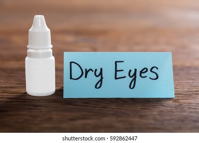 Dry Eyes Concept With Eye Drops On Wooden Desk