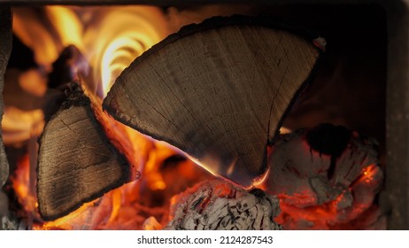 Dry firewood burns in a rural stove close up. Hot coal. Red flame of burning firewood. Fire in the fireplace. Background on the desktop.
 - Powered by Shutterstock